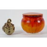 A Poole pottery style biscuit barrel, glazed in flowing orange,