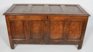 An oak coffer, 18th century, with quadruple panelled top and front,