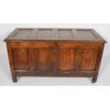 An oak coffer, 18th century, with quadruple panelled top and front,