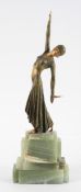 An Art Deco style lady dancer, wearing a snakeskin style dress, on a stepped marble base,