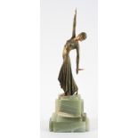 An Art Deco style lady dancer, wearing a snakeskin style dress, on a stepped marble base,