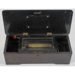 A Swiss music box, with a single cylinder, the case with inlaid floral decoration,