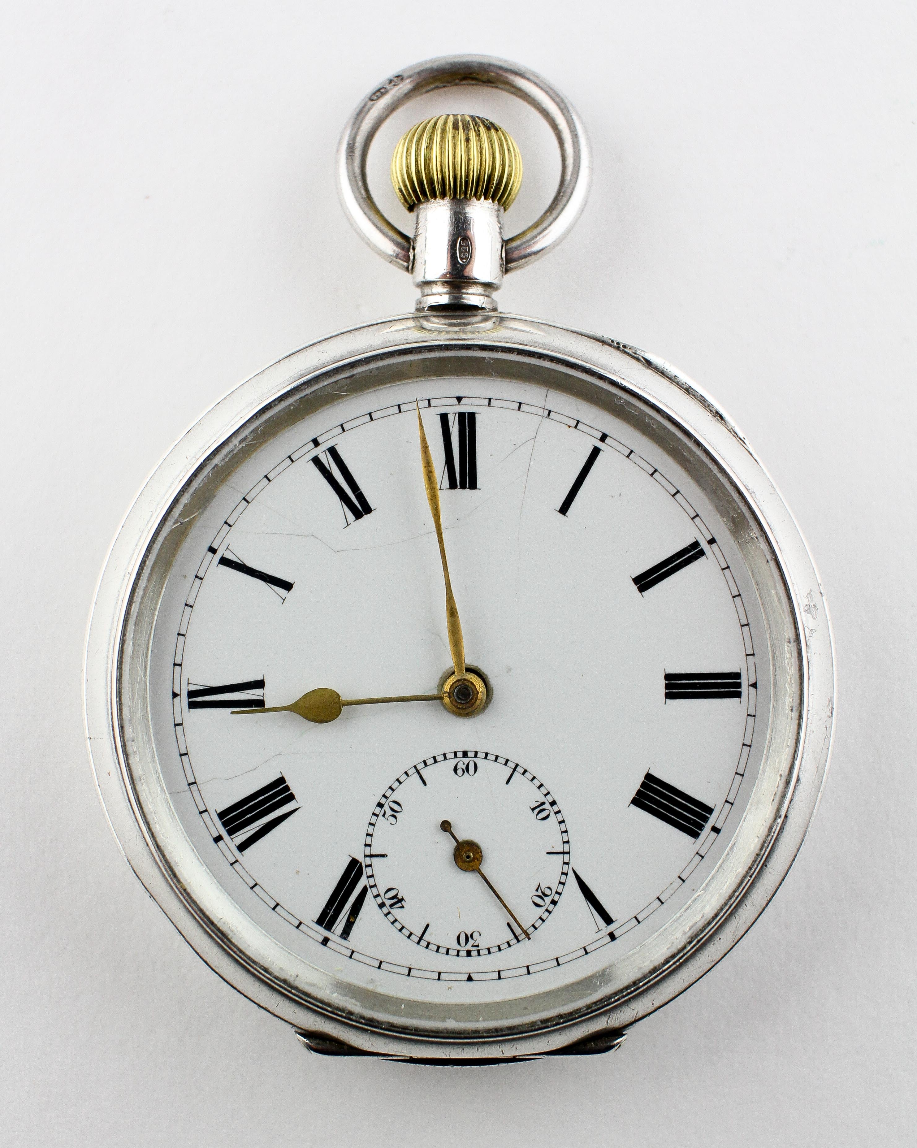 An open face pocket watch. Circular white dial with roman numerals.