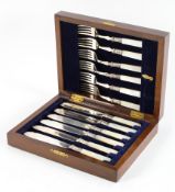 A cased set of mother of pearl handled silver plated fish cutlery,