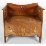 An Arts and Crafts oak settle or chair, with a pierced motif to the back and handles to the sides,