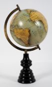 A modern globe with printed gores and turned ebonised plinth,