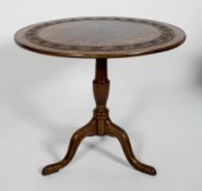 A Victorian oak circular tilt top tripod table, with carved decoration,