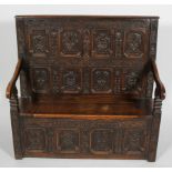 A late Victorian oak settle,