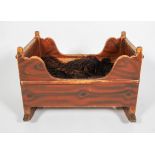 Folk Art : A 19th century pegged and painted pine cradle, probably Continental, of sleigh bed form,