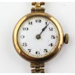 A yellow metal wristwatch. Circular white 25.0mm dial with numerical markings. Manual wind movement.