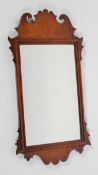 A George II style walnut fret work mirror, the rectangular plate inside a scrolling frame,