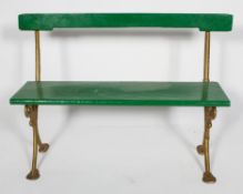 A bench, possibly from a tram, with painted wood back rest and seat,