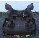 A Victorian cast iron boot scraper with leopard head monopodia on a canted rectangular tray,