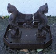 A Victorian cast iron boot scraper with leopard head monopodia on a canted rectangular tray,