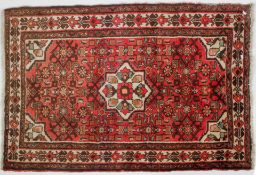 A Hamadan rug, a central star motif on abrashed pink ground 160cm x 110cm; and a Balouch Prayer rug,