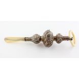 An Edwardian silver babies rattle with mother of pearl handle and teether,