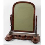 A Victorian walnut toilet swing mirror, the arched plate on scrolling supports and base,