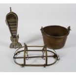 A brass peacock tail fire screen, 62cm high; a brass kitchen hanger, 57cm long and a large jam pan,