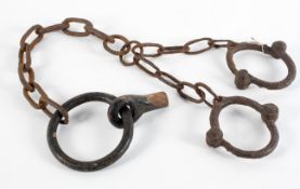 A set of slavery or prison iron ankle manacles with a fixing bolt,