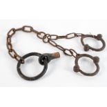 A set of slavery or prison iron ankle manacles with a fixing bolt,