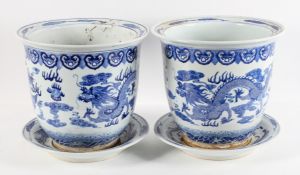 A pair of Chinese Kangxi style blue and white jardinieres and stands, 20th century,