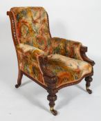 A Victorian oak framed armchair, with button back, serpentine seat and carved front legs,