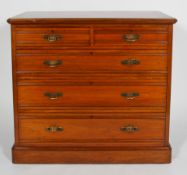 An aesthetic style walnut chest of two short and three graduated long drawers with moulded