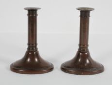 A pair of bronze candlesticks, 17th century style, on oval bases,