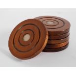 A set of six mahogany and silver mounted coasters,