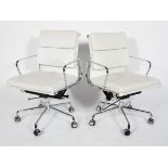 After Charles & Ray Eames, a pair of contemporary EA208 style soft pad swivel chairs,