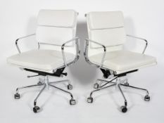 After Charles & Ray Eames, a pair of contemporary EA208 style soft pad swivel chairs,