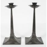 A pair of Arts and Crafts style hammered pewter candlesticks, by James Dixon and Sons,