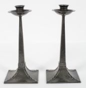 A pair of Arts and Crafts style hammered pewter candlesticks, by James Dixon and Sons,