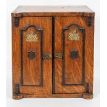 A novelty oak Smoker's cabinet, in the form of a safe,