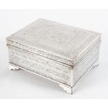 A Middle Eastern white metal cigarette box and cover,