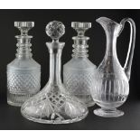 A pair of Georgian cut glass decanters of circular form with original stoppers,