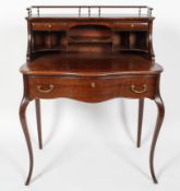 A Louis XV style oak ladies writing desk, the galleried super structure above a serpentine surface,