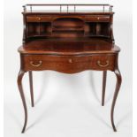 A Louis XV style oak ladies writing desk, the galleried super structure above a serpentine surface,