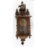A Vienna style walnut wall clock, with a 13cm chapter ring, the case surmounted by a rearing horse,