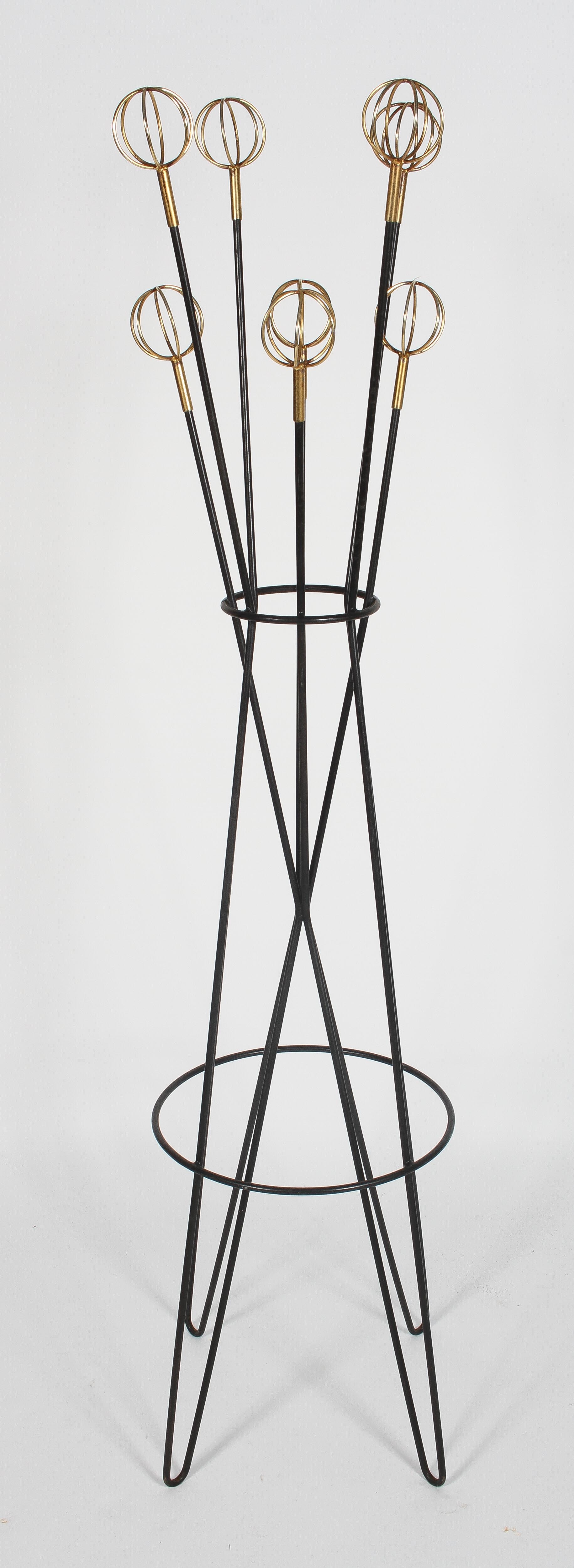 A contemporary sputnik atomic hairpin coat stand, being ebonised with gilt spherical finials,