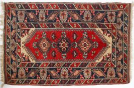 A Dosemalti (West Turkey) rug, with three lozenges on a red ground inside multiple borders,