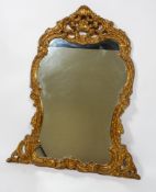 A large late 20th century carved gilt wood mirror, of rococo form,