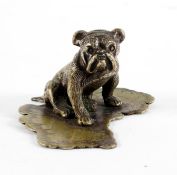 A silver plated figure of a bulldog seated on base with the shape of Australia,