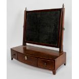 A George III mahogany toilet mirror, rectangular plate on a four fronted base with three drawers,