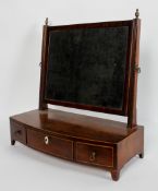 A George III mahogany toilet mirror, rectangular plate on a four fronted base with three drawers,