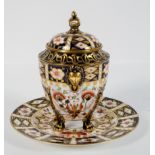 A Royal Crown Derby Imari pattern lidded urn, raised upon four lion paw feet,