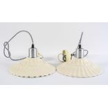 A pair of moulded cream ware ceiling light shades, of ripple form, being re-wired,