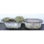 A pair of reconstituted stone troughs, of rounded rectangular form, with swag decoration,