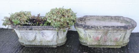 A pair of reconstituted stone troughs, of rounded rectangular form, with swag decoration,