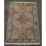 A Middle Eastern carpet the central cream ground with central medallion and floral decoration